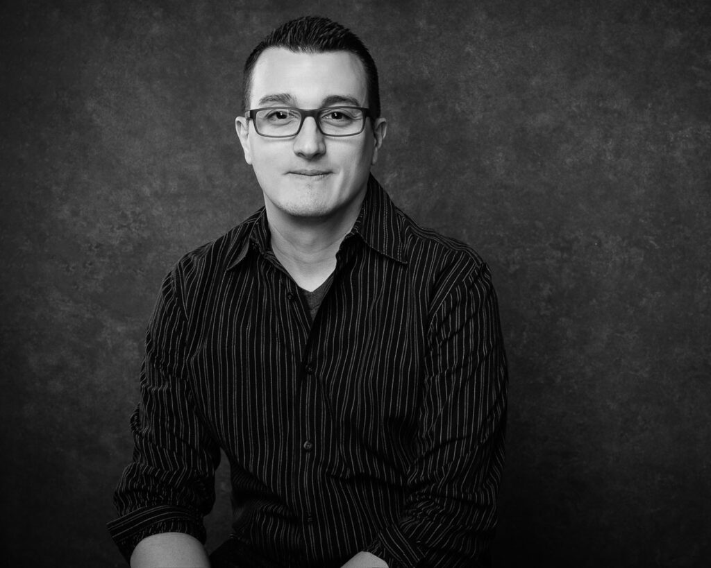 Photographer Christopher Reynolds stanind in a photography studio.